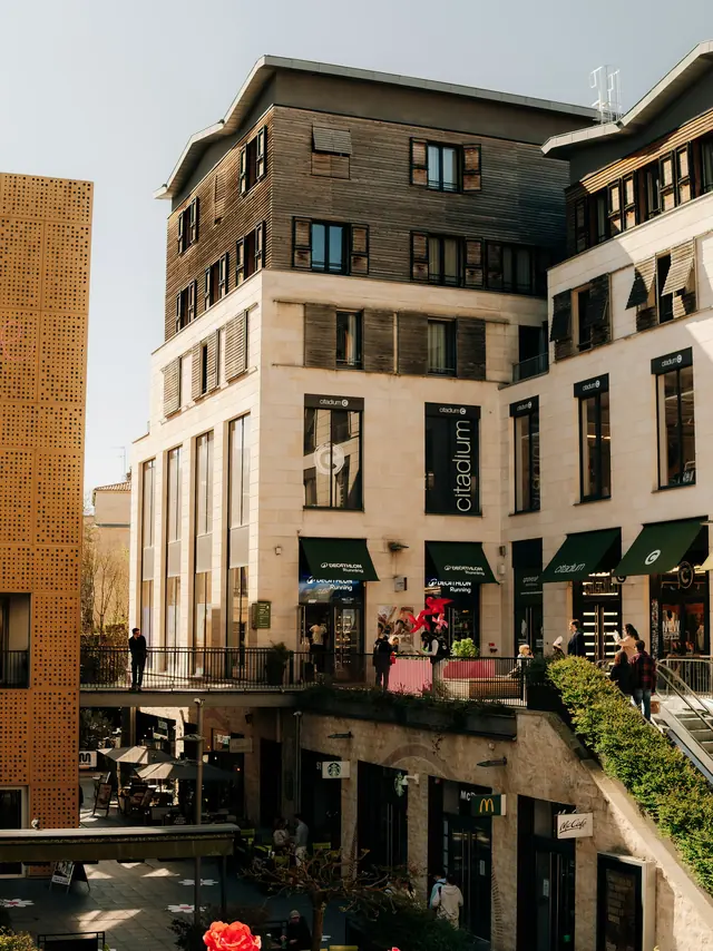 Shopfronts and cafe frontage along a mixed-use retail building